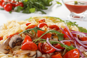 Pasta with mushrooms, cherry tomatoes and tomato sauce, italian food. Closeup