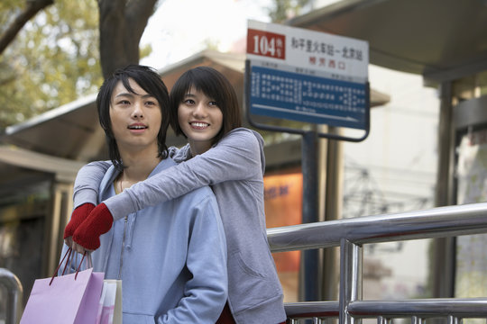 Young Couple Waiting At A Bus Station