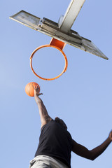 Naklejka premium Basketball player jumping to dunk