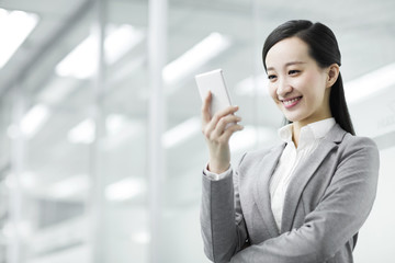 Happy businesswoman with smart phone