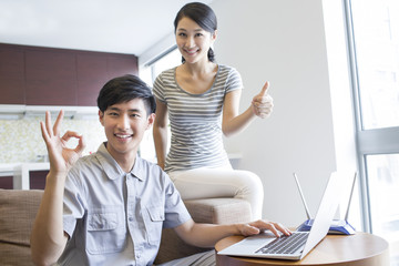 Engineer repairing laptop in customer's home