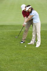 Fototapeta premium Golf coach teaching playing golf