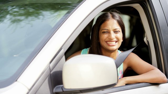 Portrait of happy confident Indian American female with car insurance