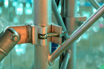 Scaffolding clamps / Close up metal scaffolding clamps under the party light.