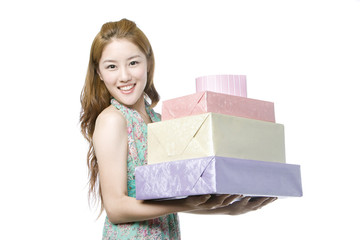 Young woman holding gift boxes