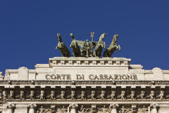 Architectural close up of the rooftop of Palace of Justice in Rome, Italy, with an equestrian statue with four horses