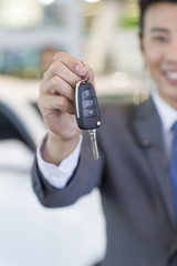 Salesman showing car key