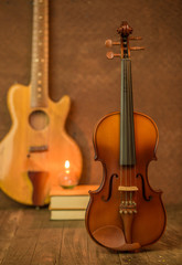 Fototapeta na wymiar Acoustic guitar,violin,book on floor and steel background inter