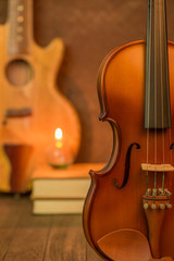 Acoustic guitar,violin,book  on floor and steel background inter