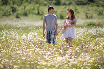 Fototapeta premium Young family on field