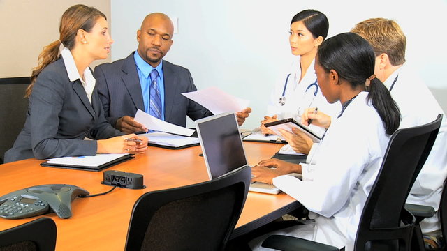 multi ethnic male female doctor hospital executive laptop tablet technology