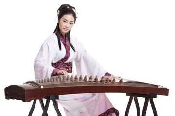 Young woman in Chinese traditional costume plucking Chinese zither