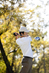 Young Man Taking a Golf Swing