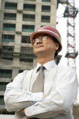 Construction Contractor Looking Up At Building