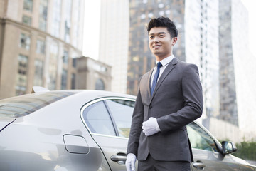 Chauffeur standing next to the car