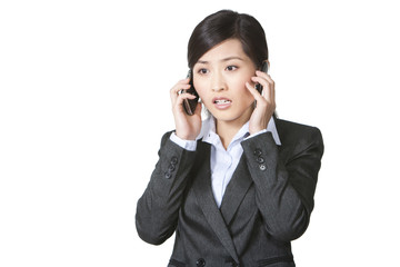 Businesswoman talking on two mobile phones