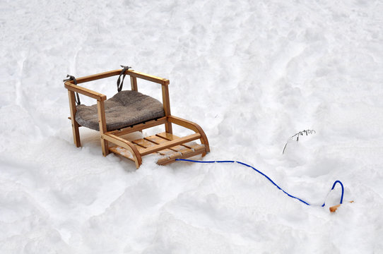 children's wooden sled in the snow