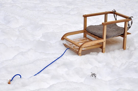 children's wooden sled in the snow