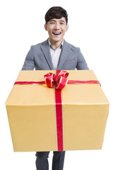 Young man laughing with a large gift