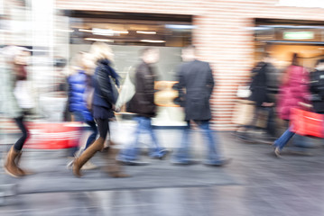 Group of people walking in shopping centre,  zoom effect, motion
