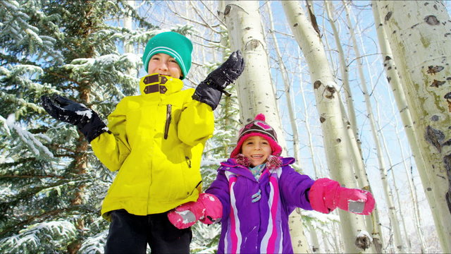 portrait outdoor active Caucasian boy girl children happy playing snow tourism