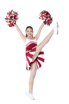 Cheerleader in action with her pom-poms
