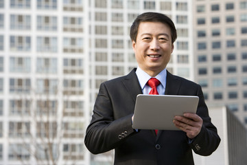 Portrait of a businessman using a digital tablet