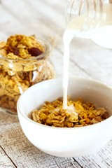 Pouring milk into granola bowl