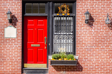 Red Wooden Door on a Brick Building