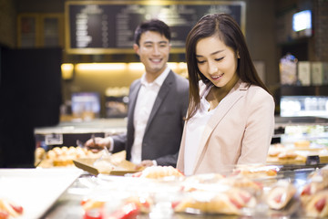 Young couple choosing breads in bakery