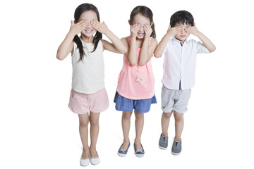 Happy children covering eyes with hands