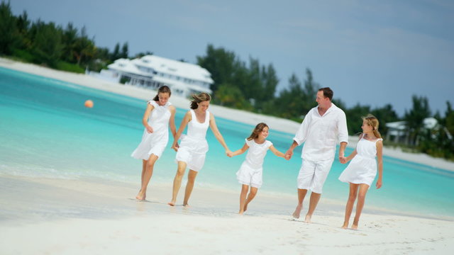 lifestyle recreation Caucasian male female family daughters tropical beach 