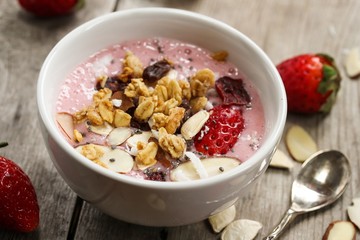 Breakfast smoothie bowl with strawberries granola nuts and Chia seeds