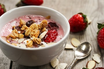 Breakfast smoothie bowl with strawberries granola nuts and Chia seeds