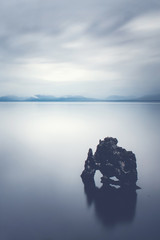 Skała w spokojnym morzu - Skała Hvitserkur na Islandii jest imponującym zabytkiem. Legenda głosi, że to troll ... - 99452484