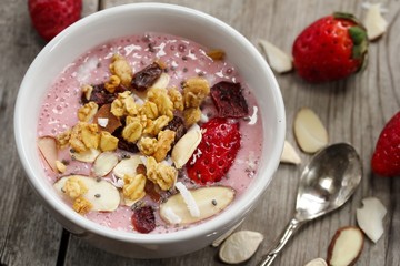 Breakfast smoothie bowl with strawberries granola nuts and Chia seeds
