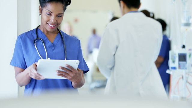 Portrait of African American female staff using technology in medical centre