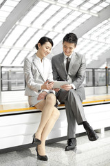 Business colleagues with digital tablet at subway station