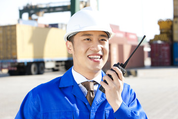 shipping industry manager with a walkie-talkie