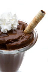 Chocolate Pudding with Whipped Cream – A parfait glass with chocolate pudding and whipped cream on top, and a cookie.