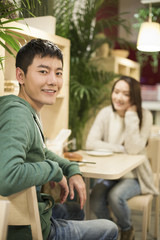 Young couple sitting in restaurant