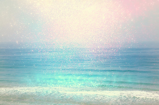 Fototapeta background of blurred beach and sea waves with bokeh lights, vintage filter.  