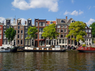 Fototapeta premium View from Amstel, Amsterdam canal, towards dutch houses