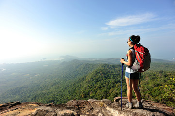 young woman backpacker enjoy the view on mountain peak
