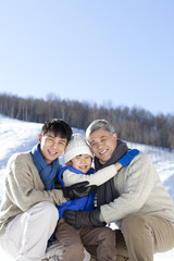 Three generation family having fun in snow