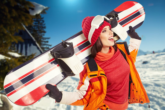 Winter woman with snowboard outdoors