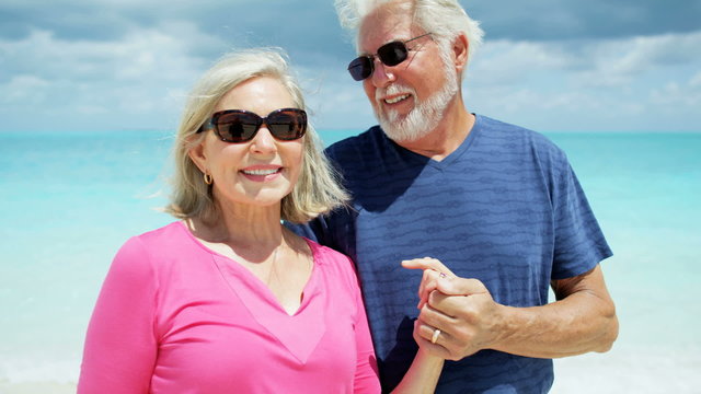 Portrait of Caucasian senior couple wearing casual beach clothes 
