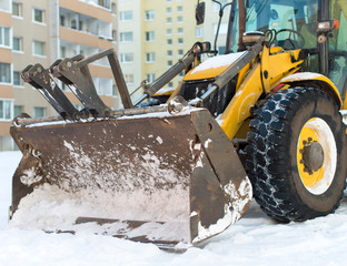 Tractor is ready to clear snow on the street.