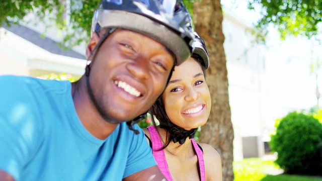 Portrait of healthy fitness African American couple cycling outdoor