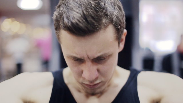Man in gym on machine exercising slow motion